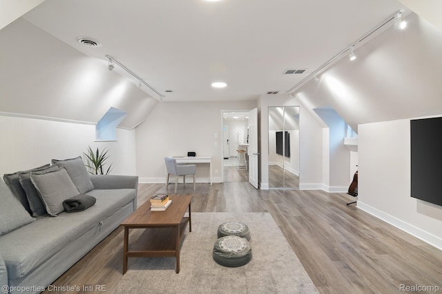 4751 Trumbull St, Detroit, MI 48208 - living area with track lighting, wood finished floors, and lofted ceiling