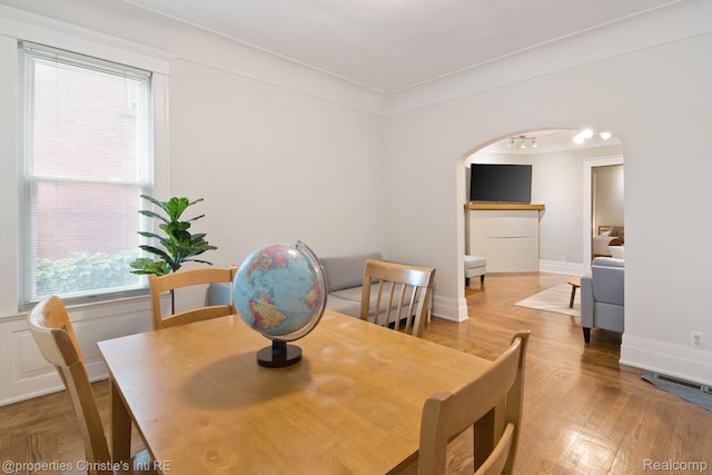 4751 Trumbull St, Detroit, MI 48208 - dining area featuring arched walkways and wood finished floors