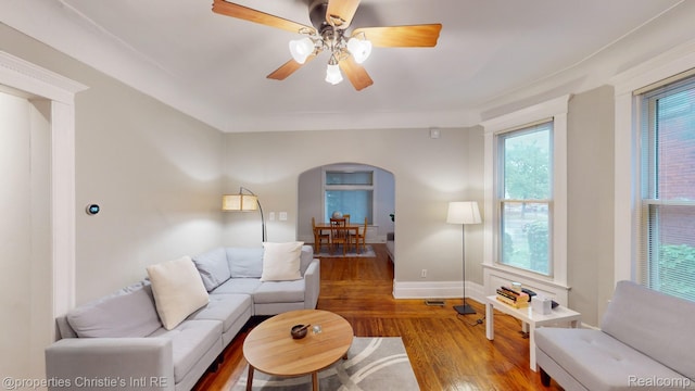 4751 Trumbull St, Detroit, MI 48208 - living area featuring arched walkways, wood finished floors, and ceiling fan