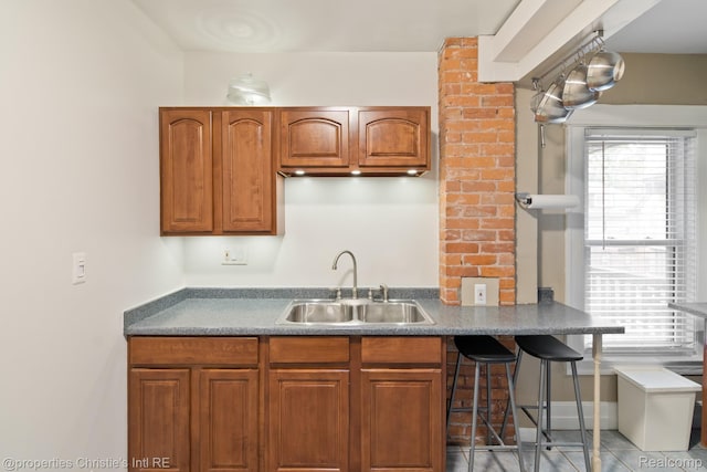 4751 Trumbull St, Detroit, MI 48208 - kitchen with plenty of natural light, brown cabinetry, and a kitchen breakfast bar