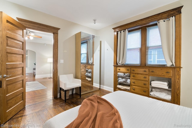 4751 Trumbull St, Detroit, MI 48208 - bedroom with arched walkways and dark wood-style flooring
