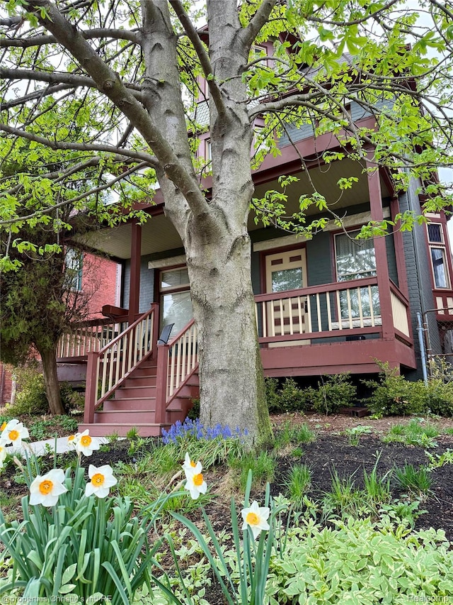4751 Trumbull St, Detroit, MI 48208 - view of side of home featuring stairway and covered porch