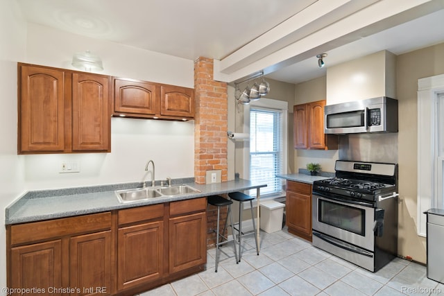 4751 Trumbull St, Detroit, MI 48208 - kitchen with stainless steel appliances, brown cabinetry, and light tile patterned floors