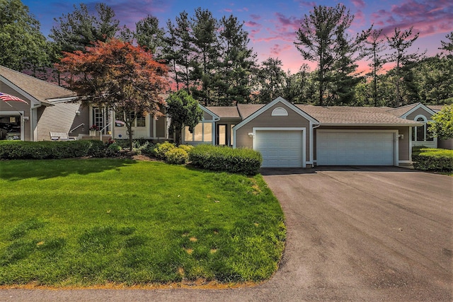 3342 Woodwind Dr NE, Grand Rapids, MI 49525 - view of front facade featuring asphalt driveway, a garage, and a lawn