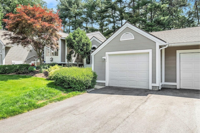 3342 Woodwind Dr NE, Grand Rapids, MI 49525 - view of front of property with a front lawn and asphalt driveway