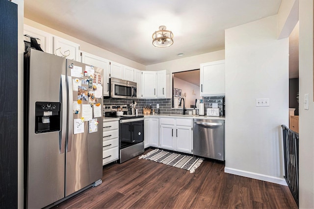 3342 Woodwind Dr NE, Grand Rapids, MI 49525 - kitchen featuring stainless steel appliances, dark wood finished floors, tasteful backsplash, light countertops, and white cabinets