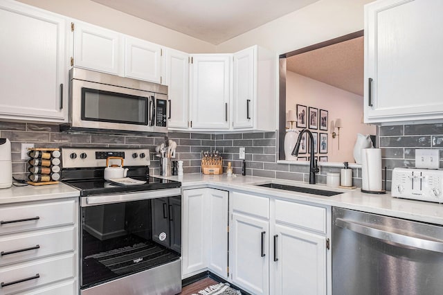 3342 Woodwind Dr NE, Grand Rapids, MI 49525 - kitchen featuring appliances with stainless steel finishes, white cabinetry, and light countertops