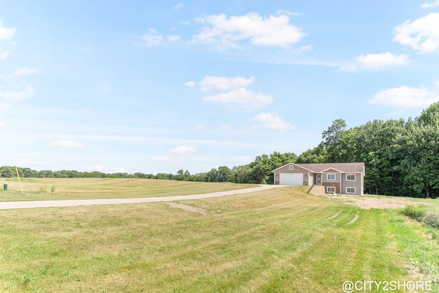 3905 Sunset Vw, Wayland, MI 49348 - view of green lawn with a garage and a view of countryside