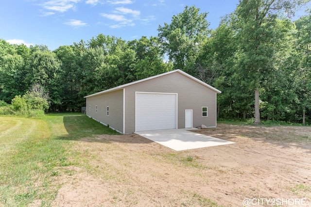 3905 Sunset Vw, Wayland, MI 49348 - detached garage featuring driveway and view of scattered trees