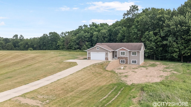3905 Sunset Vw, Wayland, MI 49348 - view of front of house featuring concrete driveway, a front yard, and a garage