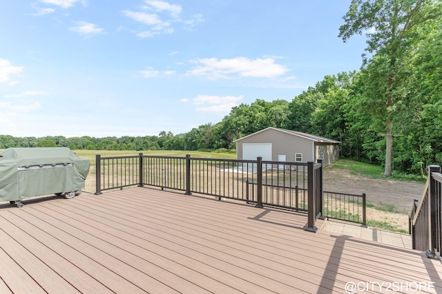3905 Sunset Vw, Wayland, MI 49348 - wooden terrace featuring a detached garage, grilling area, an outdoor structure, and view of wooded area
