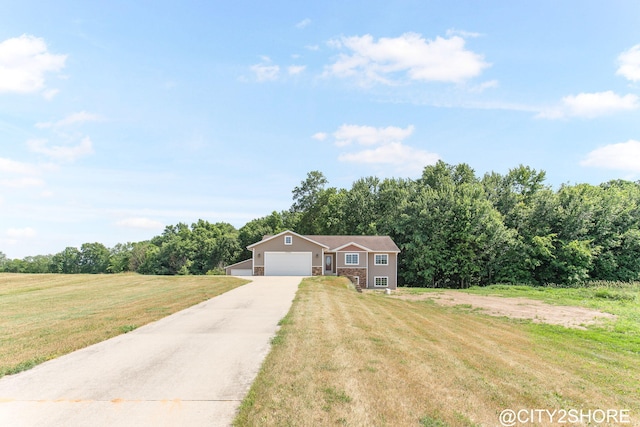 3905 Sunset Vw, Wayland, MI 49348 - view of front of house with stone siding, a front lawn, concrete driveway, and a garage