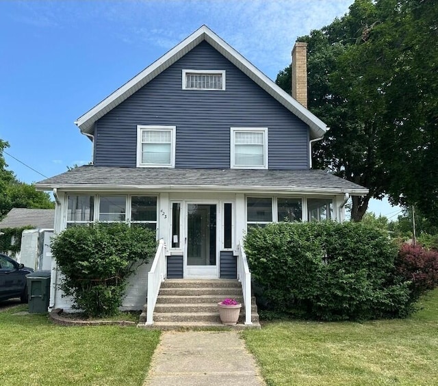 423 E Prairie St, Vicksburg, MI 49097 - view of front facade with entry steps, a chimney, a front yard, and roof with shingles