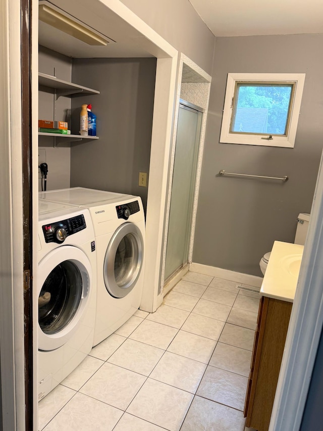 423 E Prairie St, Vicksburg, MI 49097 - laundry area with washer and clothes dryer and light tile patterned floors