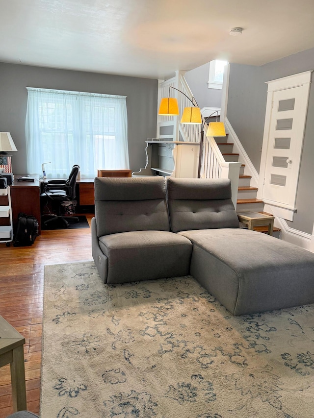 423 E Prairie St, Vicksburg, MI 49097 - living room featuring wood finished floors, healthy amount of natural light, stairway, and a desk