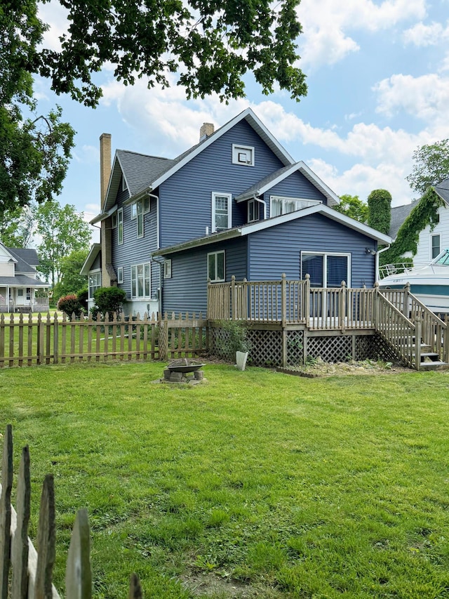 423 E Prairie St, Vicksburg, MI 49097 - back of house featuring a wooden deck and a chimney