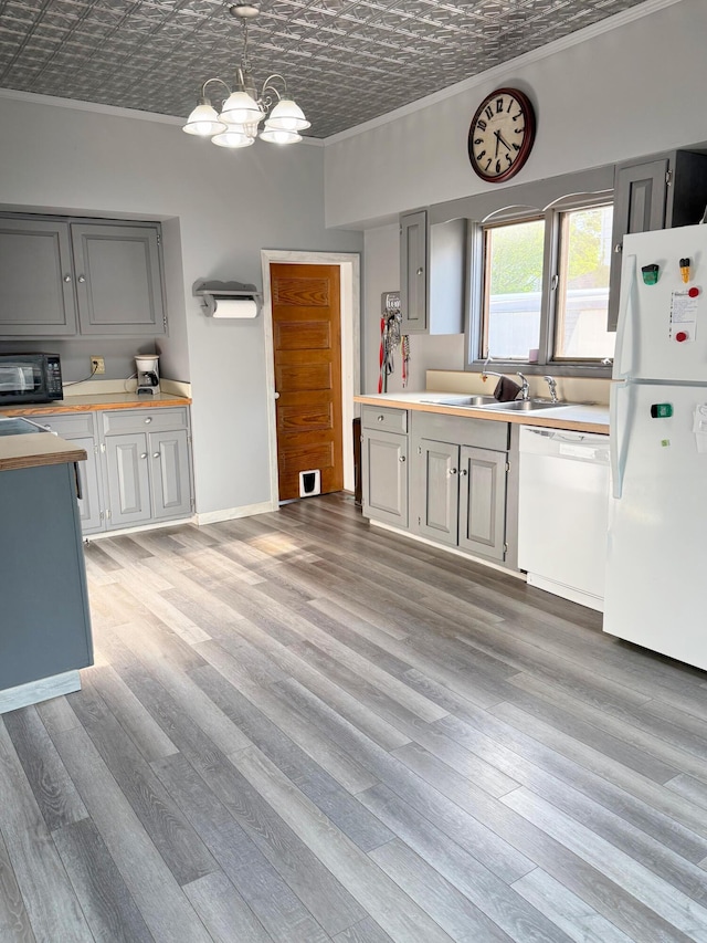 423 E Prairie St, Vicksburg, MI 49097 - kitchen with white appliances, crown molding, an ornate ceiling, gray cabinets, and light countertops