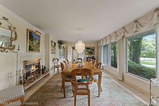 130 Endicott Rd, Bloomfield Hills, MI 48304 - dining room with a chandelier, light tile patterned flooring, a fireplace, and crown molding