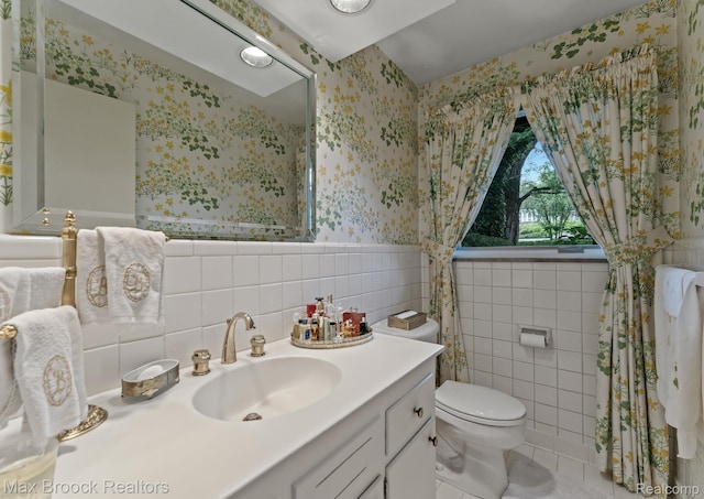 130 Endicott Rd, Bloomfield Hills, MI 48304 - bathroom featuring wallpapered walls, tile walls, vanity, tile patterned flooring, and wainscoting