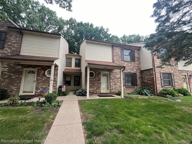 35754 Castlewood Ct, Westland, MI 48185 - view of property with brick siding and a front lawn