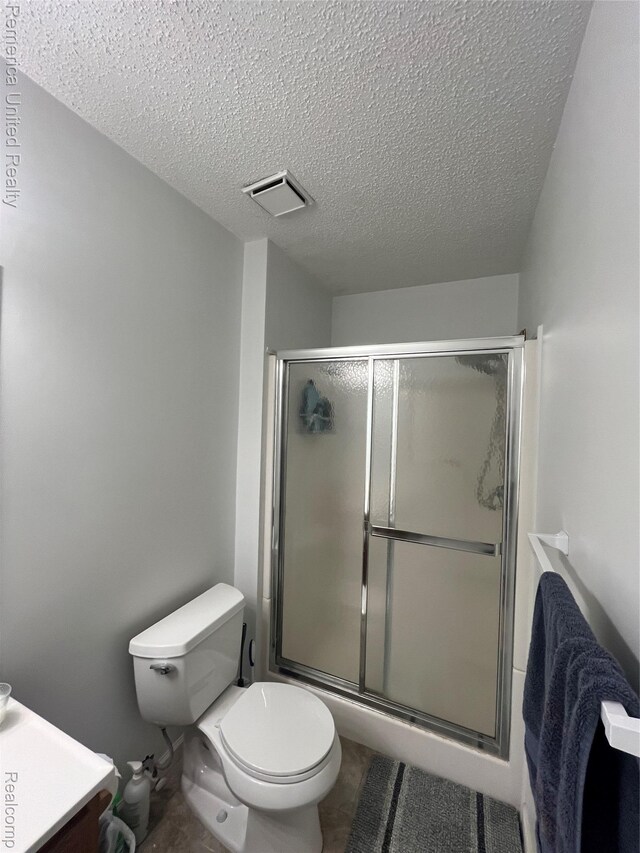 35754 Castlewood Ct, Westland, MI 48185 - bathroom featuring vanity, a textured ceiling, and an enclosed shower