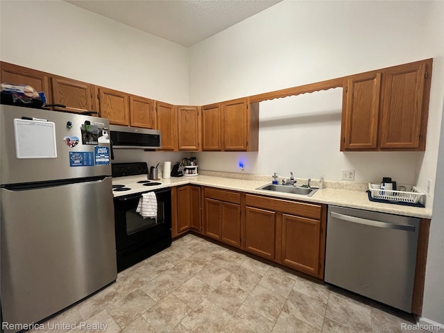35754 Castlewood Ct, Westland, MI 48185 - kitchen with stainless steel appliances, light countertops, and brown cabinetry