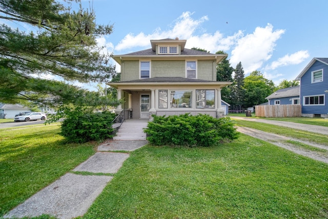 1302 Lansing Ave, Jackson, MI 49202 - american foursquare style home featuring a porch and a front yard