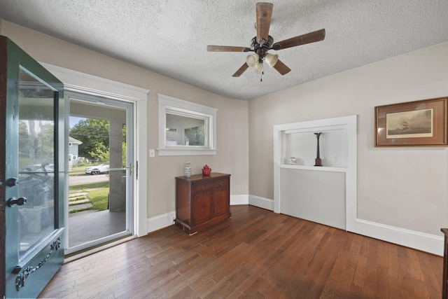 1302 Lansing Ave, Jackson, MI 49202 - foyer with a textured ceiling, dark wood-style floors, and a ceiling fan