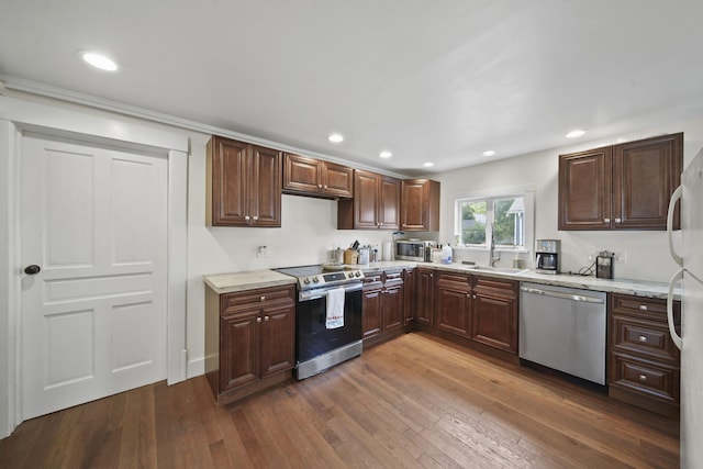 1302 Lansing Ave, Jackson, MI 49202 - kitchen featuring appliances with stainless steel finishes, dark wood-style floors, recessed lighting, light stone countertops, and dark brown cabinets
