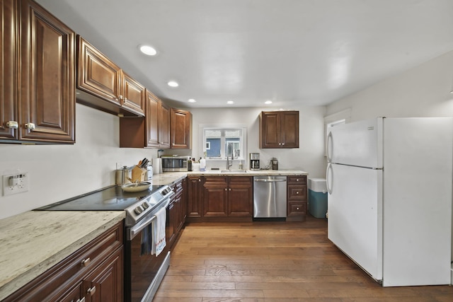 1302 Lansing Ave, Jackson, MI 49202 - kitchen featuring stainless steel appliances, recessed lighting, dark wood finished floors, and dark brown cabinets