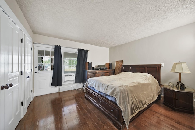1302 Lansing Ave, Jackson, MI 49202 - bedroom with a textured ceiling, wood-type flooring, and cooling unit
