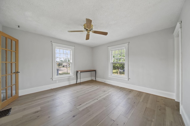 1302 Lansing Ave, Jackson, MI 49202 - unfurnished room featuring a textured ceiling, wood finished floors, and ceiling fan