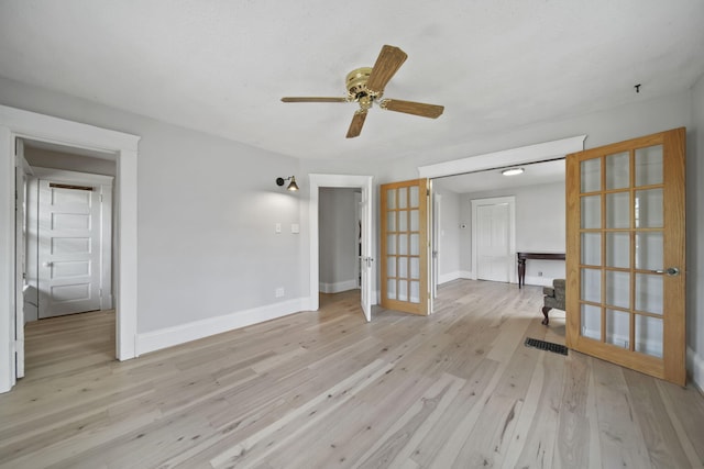 1302 Lansing Ave, Jackson, MI 49202 - unfurnished room with french doors, light wood finished floors, and ceiling fan