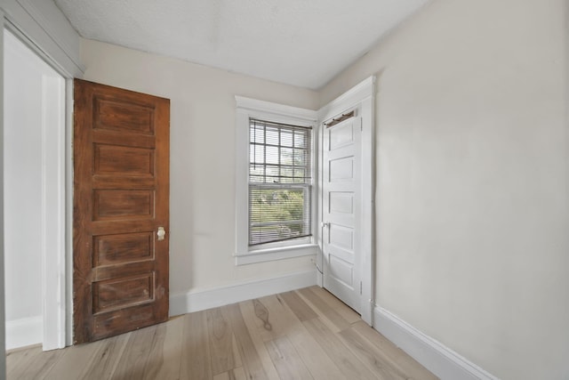1302 Lansing Ave, Jackson, MI 49202 - spare room with light wood-type flooring and baseboards