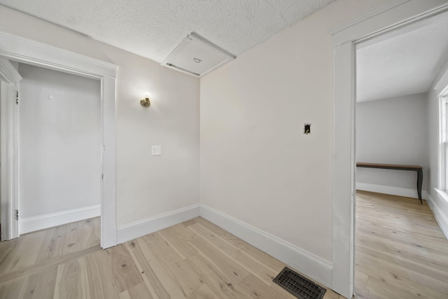 1302 Lansing Ave, Jackson, MI 49202 - spare room featuring light wood-style flooring and a textured ceiling