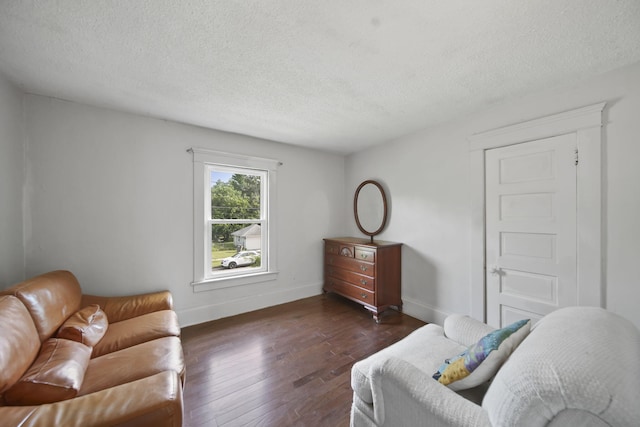 1302 Lansing Ave, Jackson, MI 49202 - living room featuring dark wood-type flooring and a textured ceiling