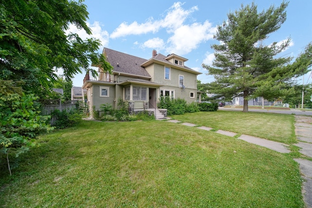 1302 Lansing Ave, Jackson, MI 49202 - back of house with a chimney and a balcony
