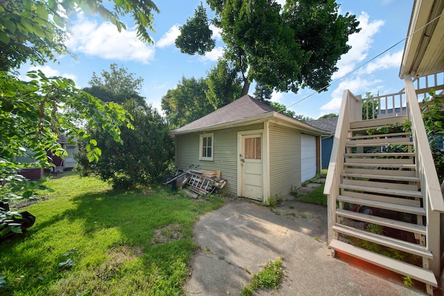 1302 Lansing Ave, Jackson, MI 49202 - view of grassy yard featuring stairway and an outdoor structure