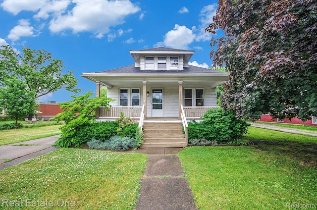 22500 Boulder Ave, Eastpointe, MI 48021 - bungalow-style house with covered porch, a front lawn, and roof with shingles