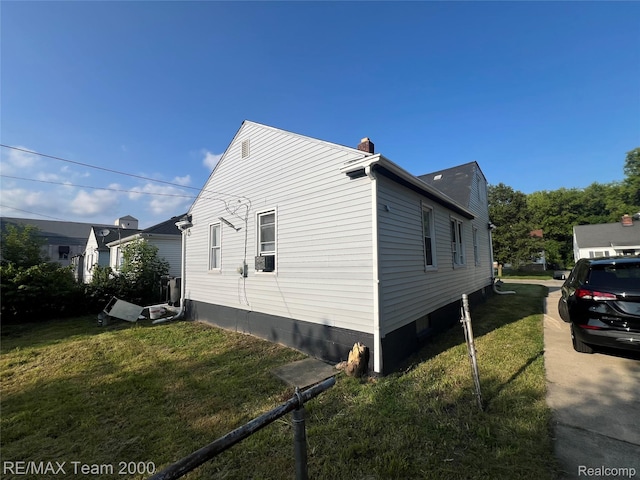 4064 Moore St, Inkster, MI 48141 - view of property exterior featuring a lawn, a chimney, and cooling unit