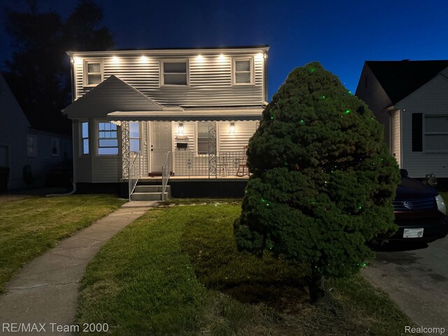 4064 Moore St, Inkster, MI 48141 - traditional-style home featuring a porch and a lawn