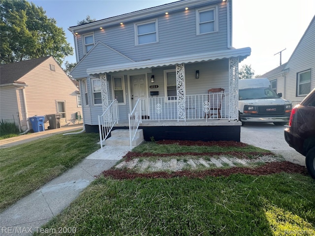 4064 Moore St, Inkster, MI 48141 - view of front facade with covered porch and a front yard