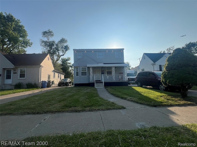 4064 Moore St, Inkster, MI 48141 - view of front of home with a porch and a front lawn
