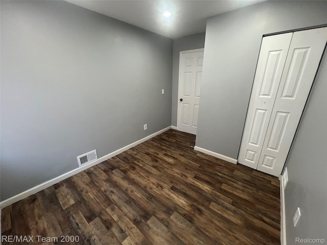 4064 Moore St, Inkster, MI 48141 - unfurnished bedroom featuring dark wood-type flooring and a closet