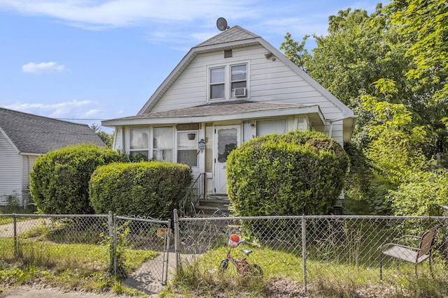 103 Webber St, Battle Creek, MI 49015 - bungalow-style home with a fenced front yard, roof with shingles, cooling unit, and entry steps