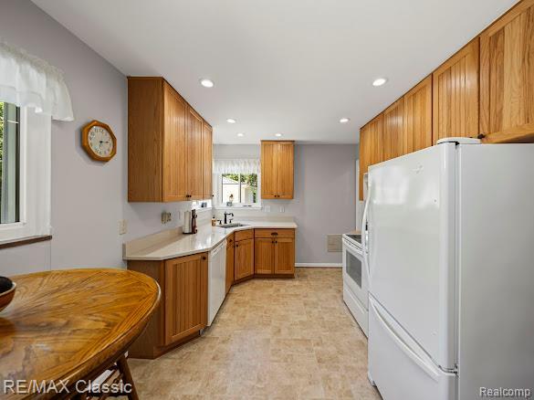 32354 Leelane, Farmington, MI 48336 - kitchen featuring white appliances, light countertops, brown cabinets, and recessed lighting