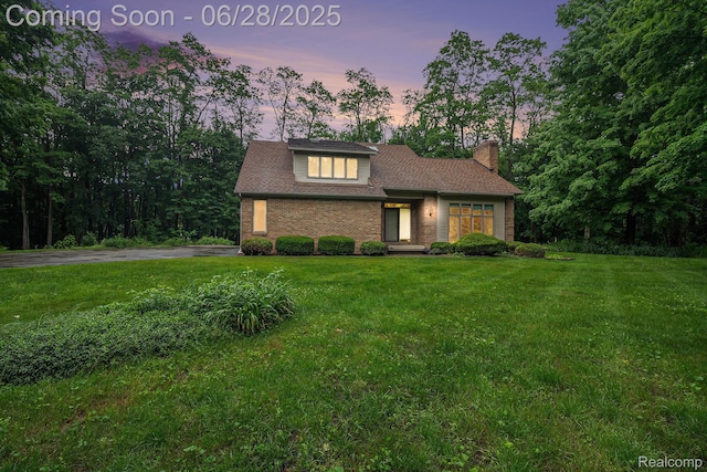 6375 Perryville Rd, Holly, MI 48442 - view of front of home with a chimney and a yard