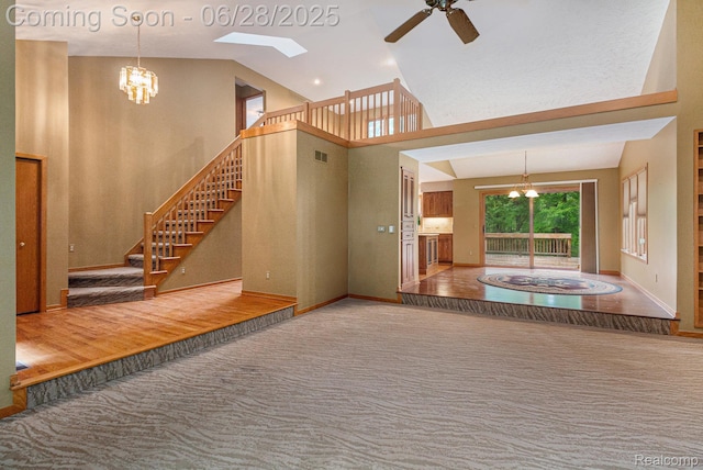 6375 Perryville Rd, Holly, MI 48442 - staircase featuring a chandelier, a skylight, carpet, ceiling fan, and high vaulted ceiling