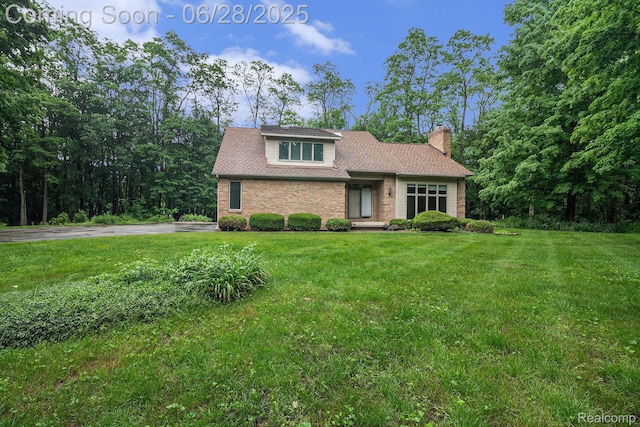6375 Perryville Rd, Holly, MI 48442 - view of front facade with a chimney and a front yard