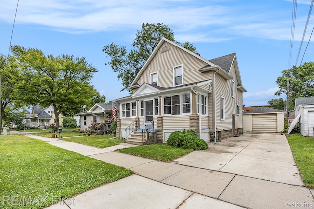 442 Washington St, Marine City, MI 48039 - view of front of house with an outbuilding, driveway, a front lawn, a detached garage, and a shingled roof
